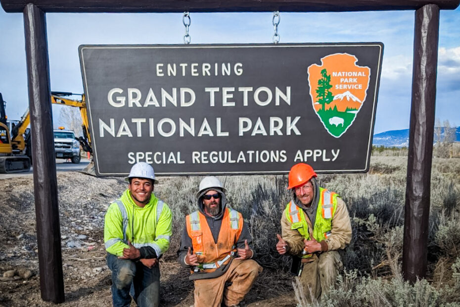 Bryan Benner, Jarrod Christensen and Joey Schultz in front of the Grand Teton National Park Entrance sign installed by S&L Industrial