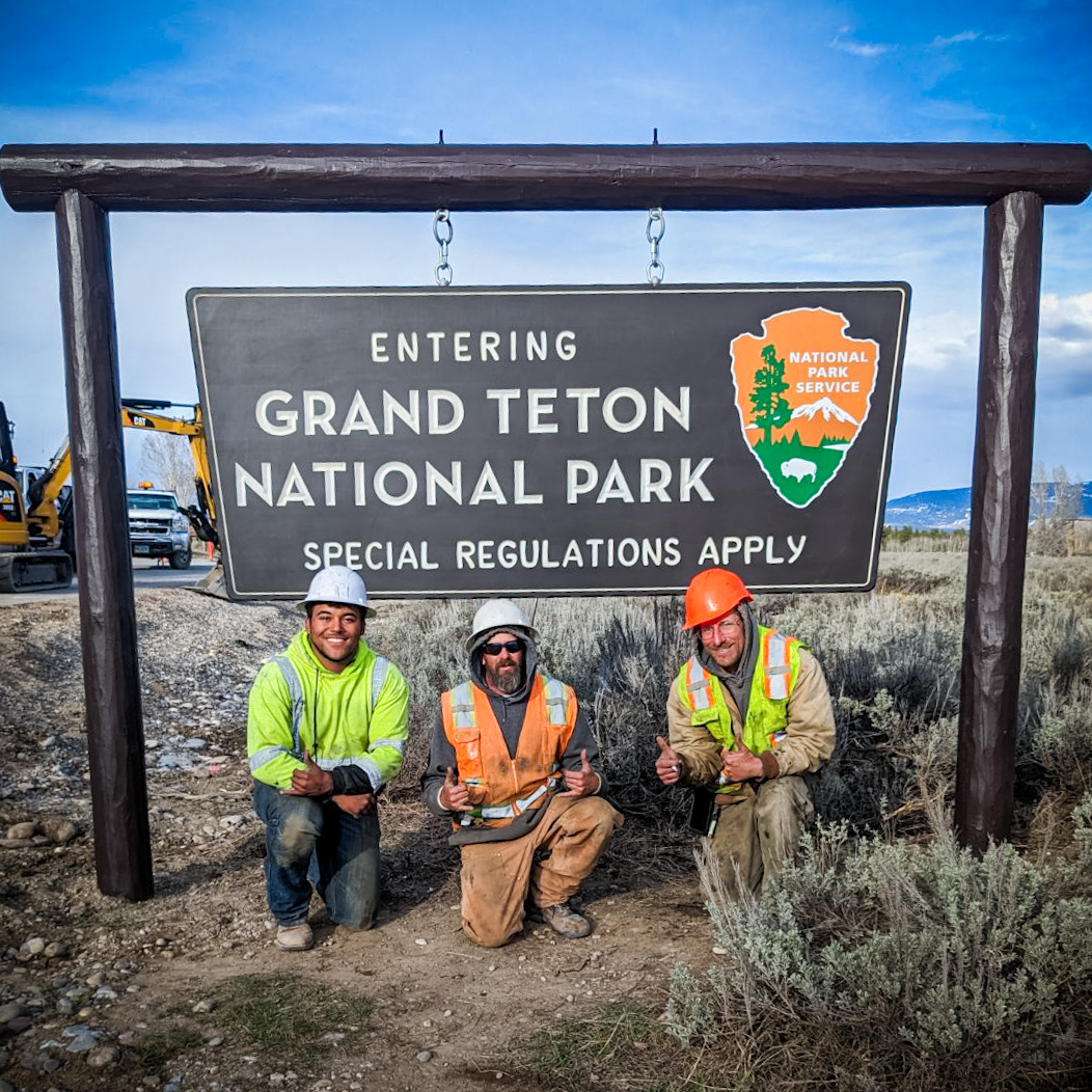 Bryan Benner, Jarrod Christensen and Joey Schultz in front of the Grand Teton National Park Entrance sign installed by S&L Industrial